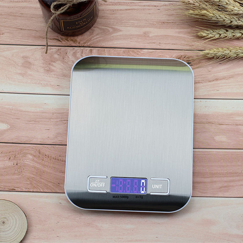 Kitchen Electronic Scale Household Food Baking Gram Measuring on wooden table with LCD display